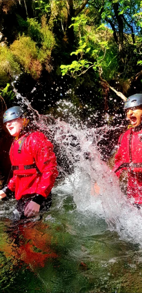Two people Ghyll scrambling in the lake district